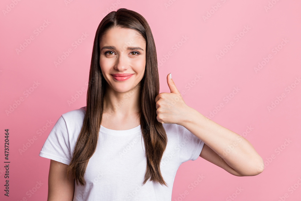 Portrait of attractive cheerful girl showing thumbup ad deal done decision isolated over pink pastel color background Portrait of attractive cheerful girl showing thumbup ad deal done decision isolated over pink pastel color background
