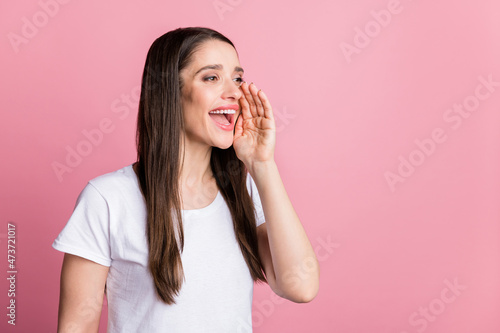 Profile side view portrait of attractive cheerful girl saying info ad copy space isolated over pink pastel color background