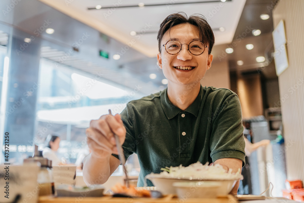 An Asian man eating lunch An Asian man eating lunch