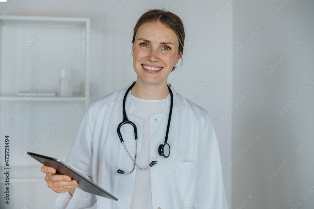 Smiling doctor holding digital tablet Smiling doctor holding digital tablet