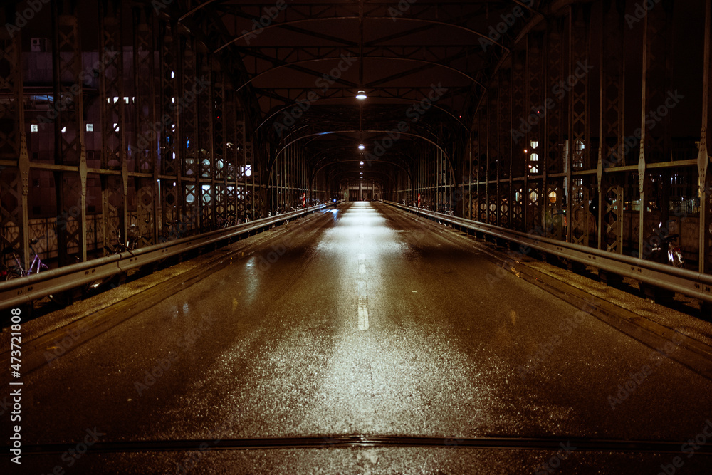 View of a wet road at night View of a wet road at night