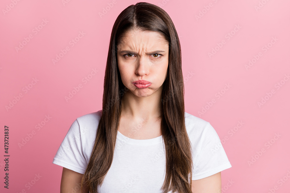 Portrait of attractive grumpy evil girl holding air in cheeks bad mood isolated over pink pastel color background Portrait of attractive grumpy evil girl holding air in cheeks bad mood isolated over pink pastel color background