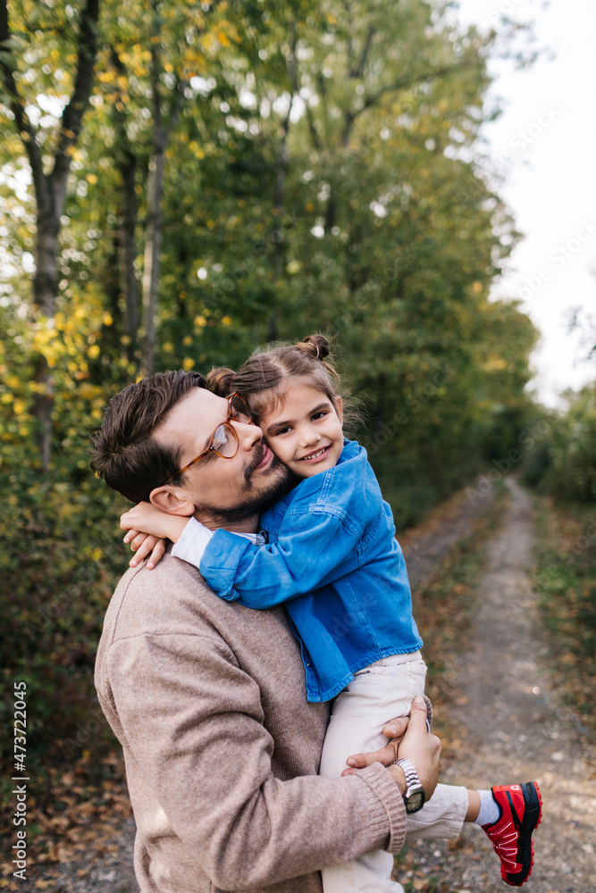 Man Holding His Daughter in His Arms Man Holding His Daughter in His Arms