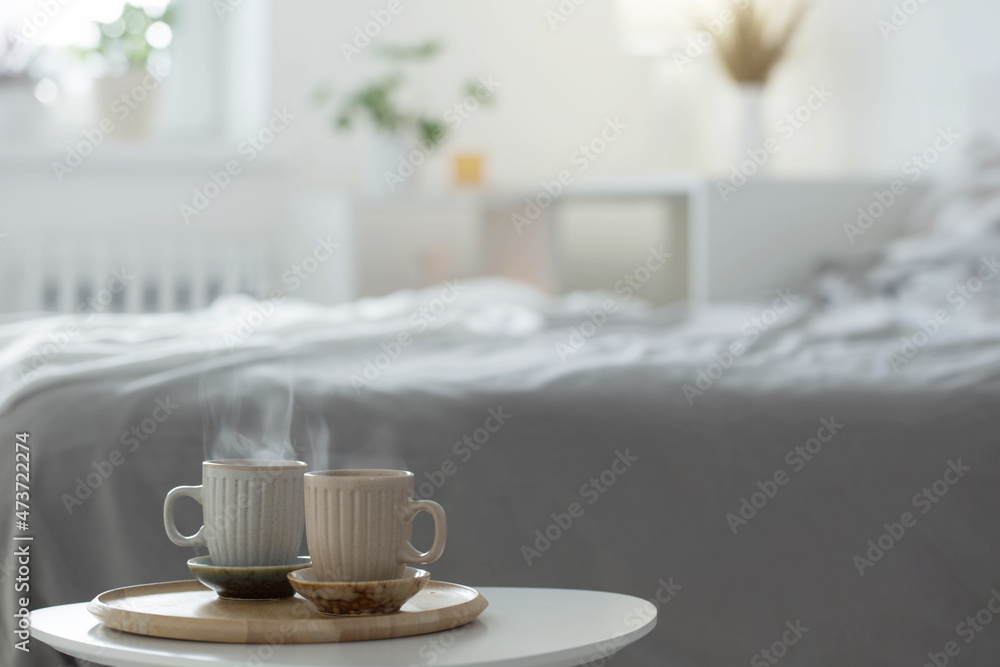 two cup of coffee on wooden tray in bedroom
