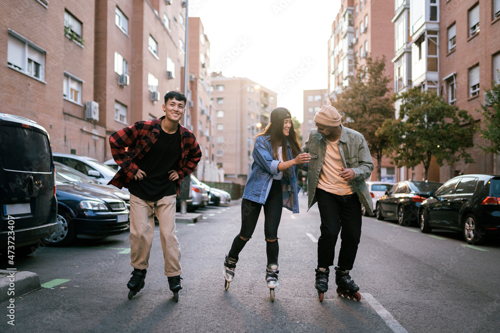 Portrait of three multiethnic young millennial skating Portrait of three multiethnic young millennial skating