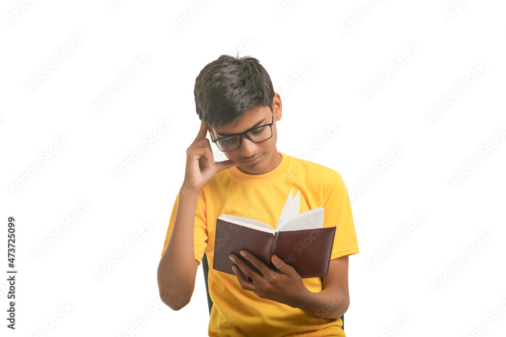 Indian boy holding diary in hand and thinking some idea on white background. Indian boy holding diary in hand and thinking some idea on white background.
