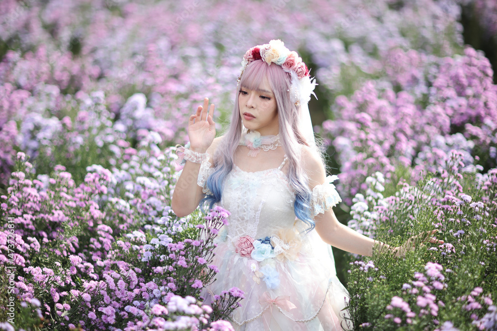 Obraz premium Beautiful young woman with white lolita dress with flowers garden Japanese fashion