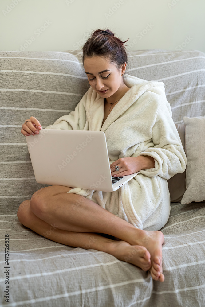 young beautiful girl working on a laptop in bed during quarantine. young beautiful girl working on a laptop in bed during quarantine.