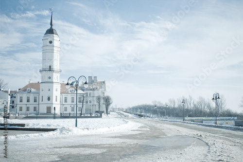 Snowy winter landscape with historical building of city hall of Mogilev, Belarus. Central city square on the embankment of river Dnepr photo