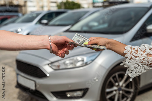 success deal to buy car, man gives dollar salesman © RomanR