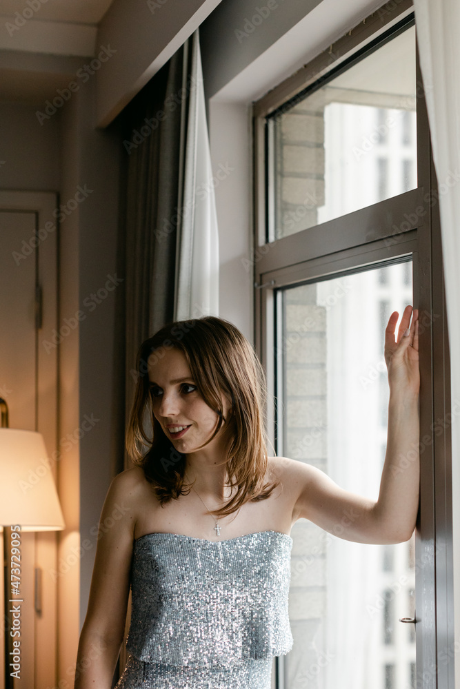 Bride Standing in Window at Hotel Bride Standing in Window at Hotel