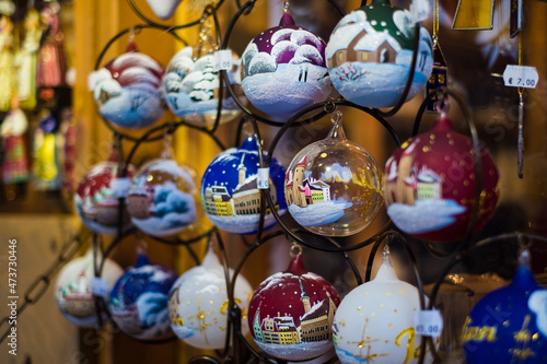 Hanging ornaments on sale at Tallinn Christmas market. Christmas decoration. Hand painted souvenirs or gifts. Northern Europe holiday traditions. 