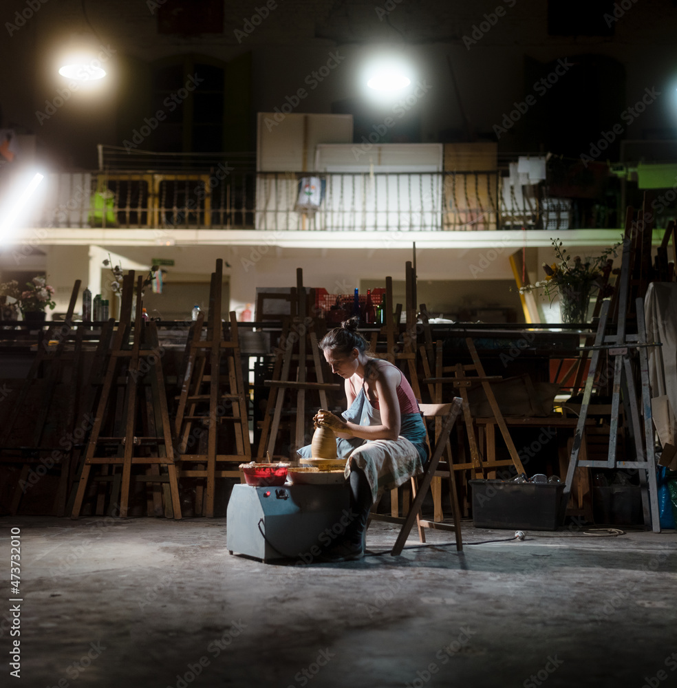 Pottery artist working at her studio Pottery artist working at her studio