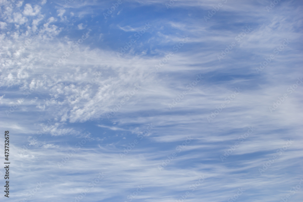Background white cirrus clouds on the background blue sky. Background white cirrus clouds on the background blue sky.