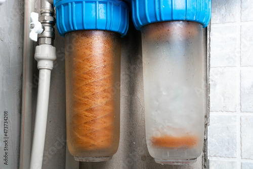 Used rusty double cartridge water filter.  Plumbing system