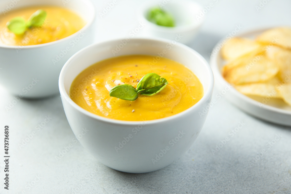 Traditional homemade pumpkin soup with fresh basil Traditional homemade pumpkin soup with fresh basil