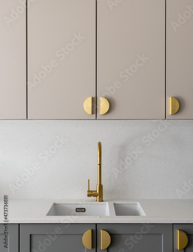 Kitchen sink and gold handles photo