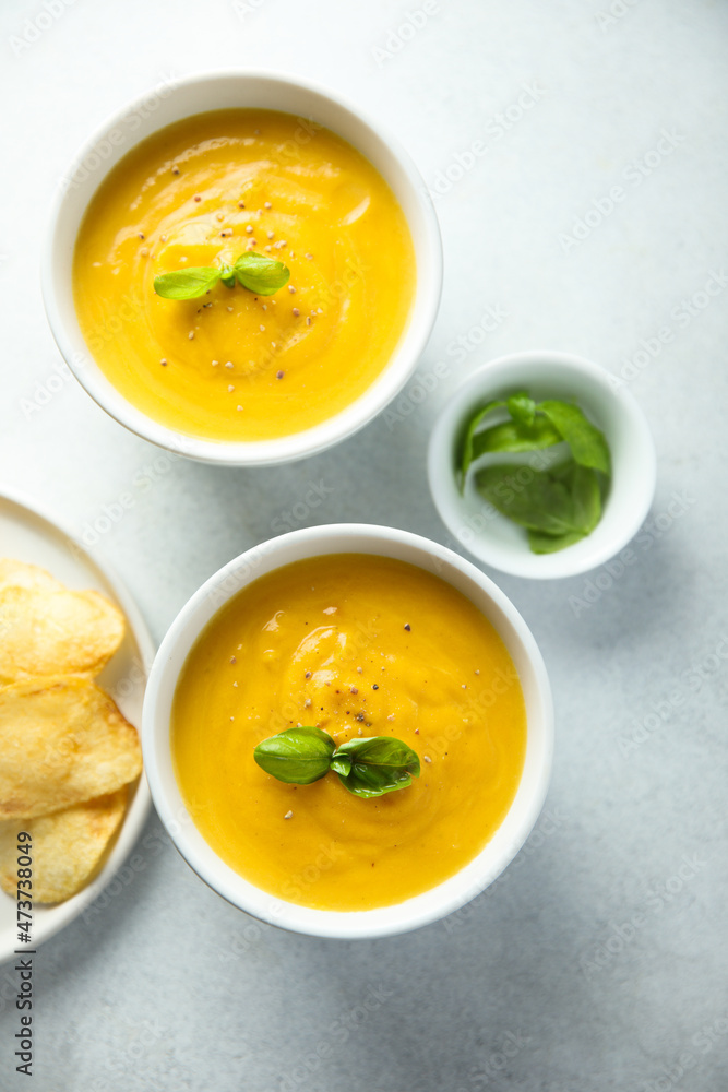 Traditional homemade pumpkin soup with fresh basil Traditional homemade pumpkin soup with fresh basil
