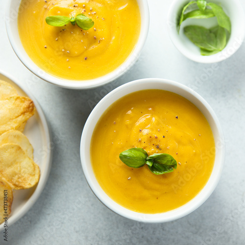 Traditional homemade pumpkin soup with fresh basil