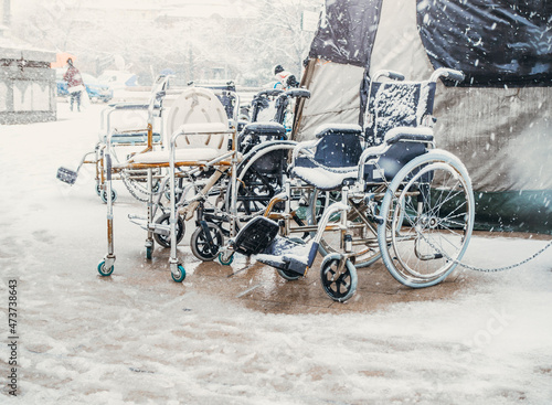 Equal rights for people with disabilities. People with disabilities protest with Tent camp in snowy winter. Close up wheelchairs with nobody photo