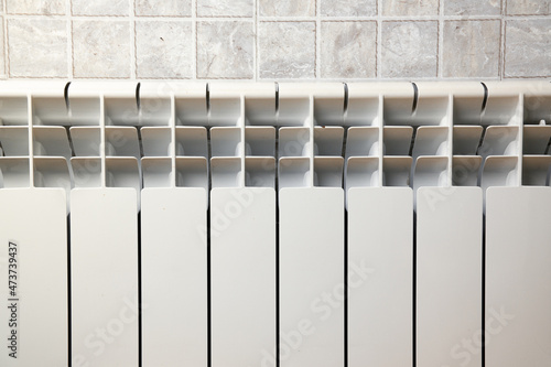 White aluminium hot water heating radiator. Heating convector in the bathroom. 8 sections.