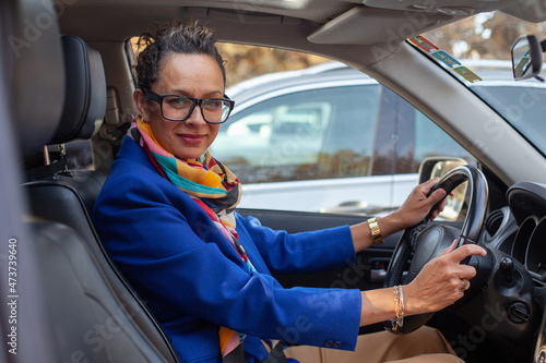 mature female portrait in the car, business woman photo