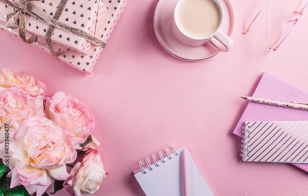 Home office workspace - cup of coffee and fresh rose flowers on pink background. Home office workspace - cup of coffee and fresh rose flowers on pink background.