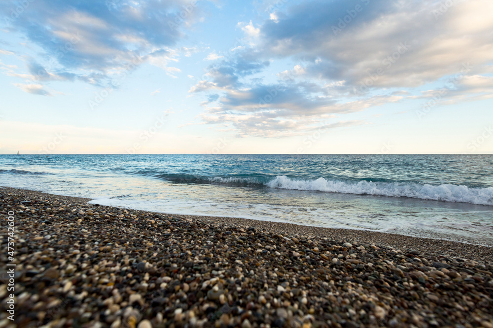 beautiful sea shore with blue water with pebbles beautiful sea shore with blue water with pebbles