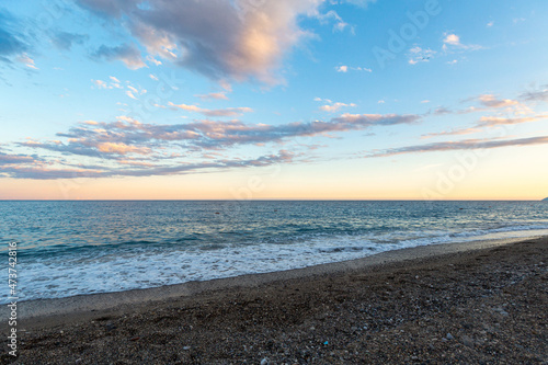 beautiful sea shore with blue water with pebbles © Nikita Shevchenko