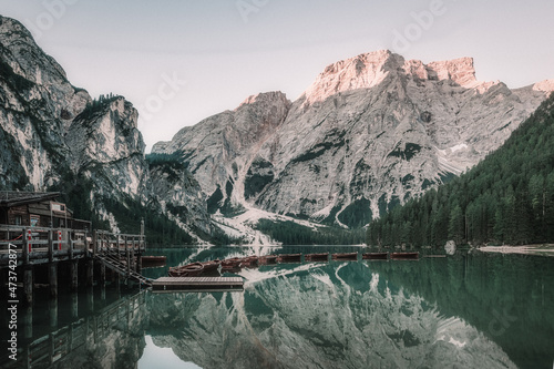 landscape of a lake with boats surrounded by mountains