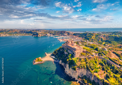 Fototapeta Naklejka Na Ścianę i Meble -  Aerial landscape photography. Beautiful view from flying drone of Aragonese Castle of Baia, Italy, Europe. Wonderful morning seascape of Mediterranean sea. Traveling concept background.