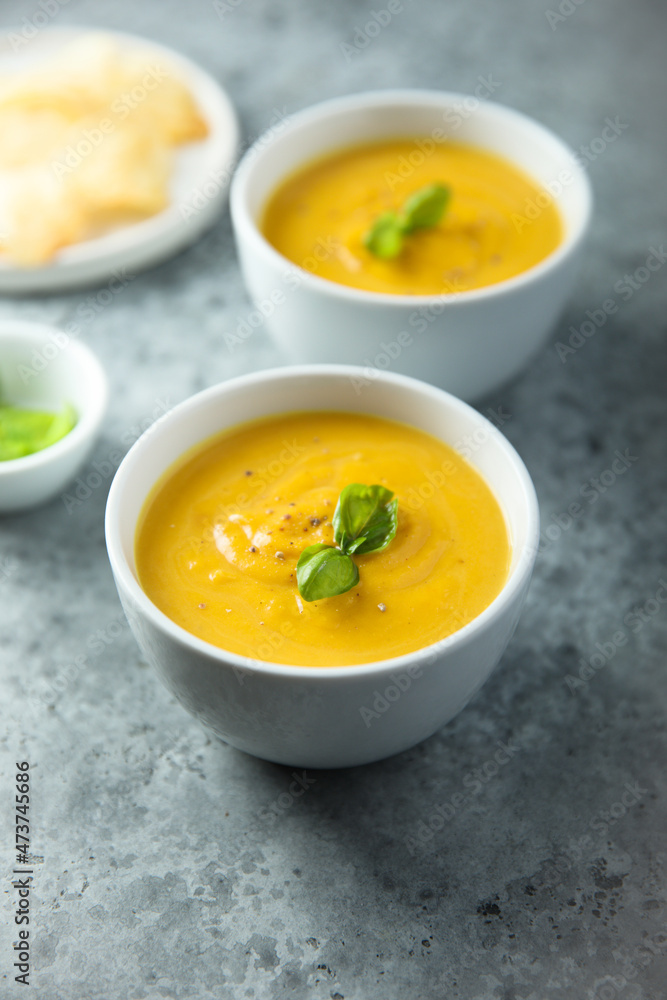 Traditional homemade pumpkin soup with fresh basil Traditional homemade pumpkin soup with fresh basil