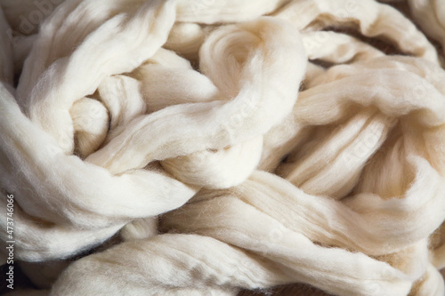 A pile of large-knit merino wool threads for knitting a plaid