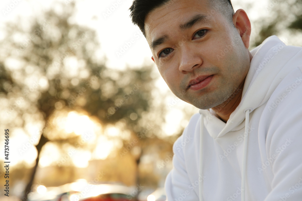 Headshot of handsome smiling young Asian man, posing outdoor. Headshot of handsome smiling young Asian man, posing outdoor.
