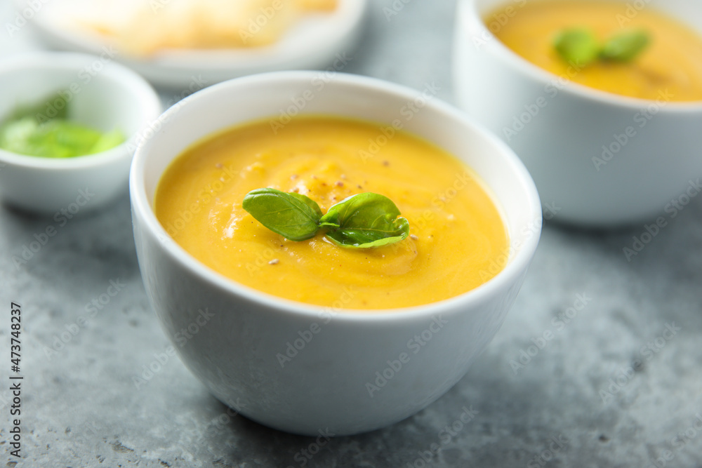 Traditional homemade pumpkin soup with fresh basil Traditional homemade pumpkin soup with fresh basil