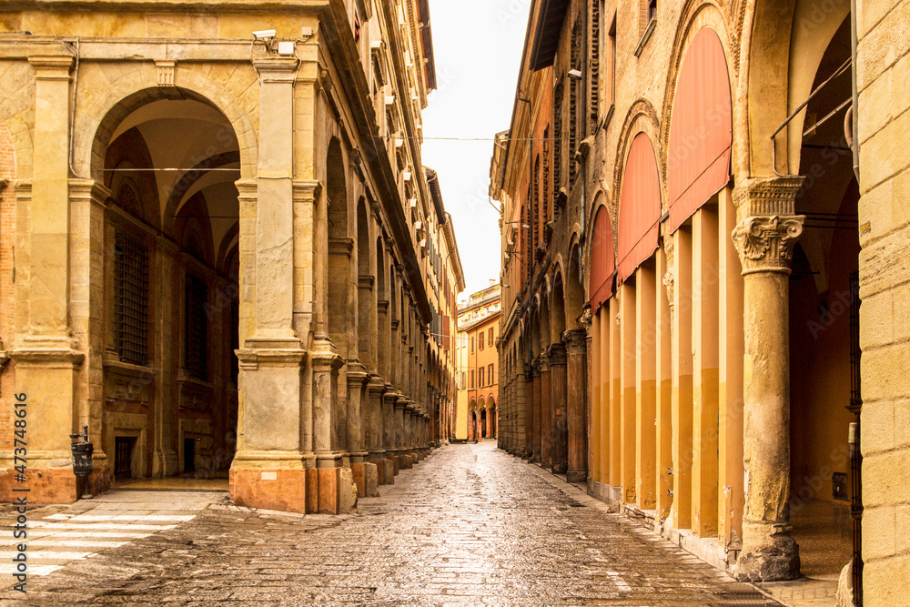 Beautiful Italian street, colourful buildings with porticos. Bologna, Italy.