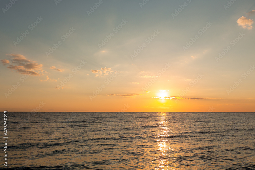 beautiful sunrise on the horizon of the blue sea
