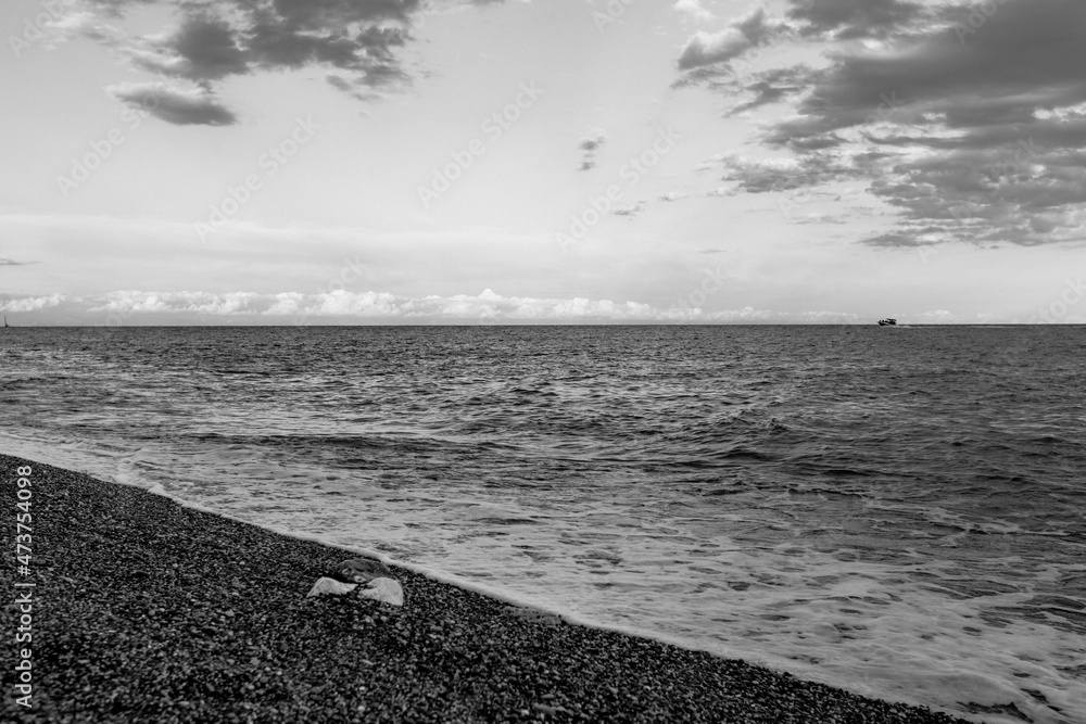 black and white sea beach with pebbles