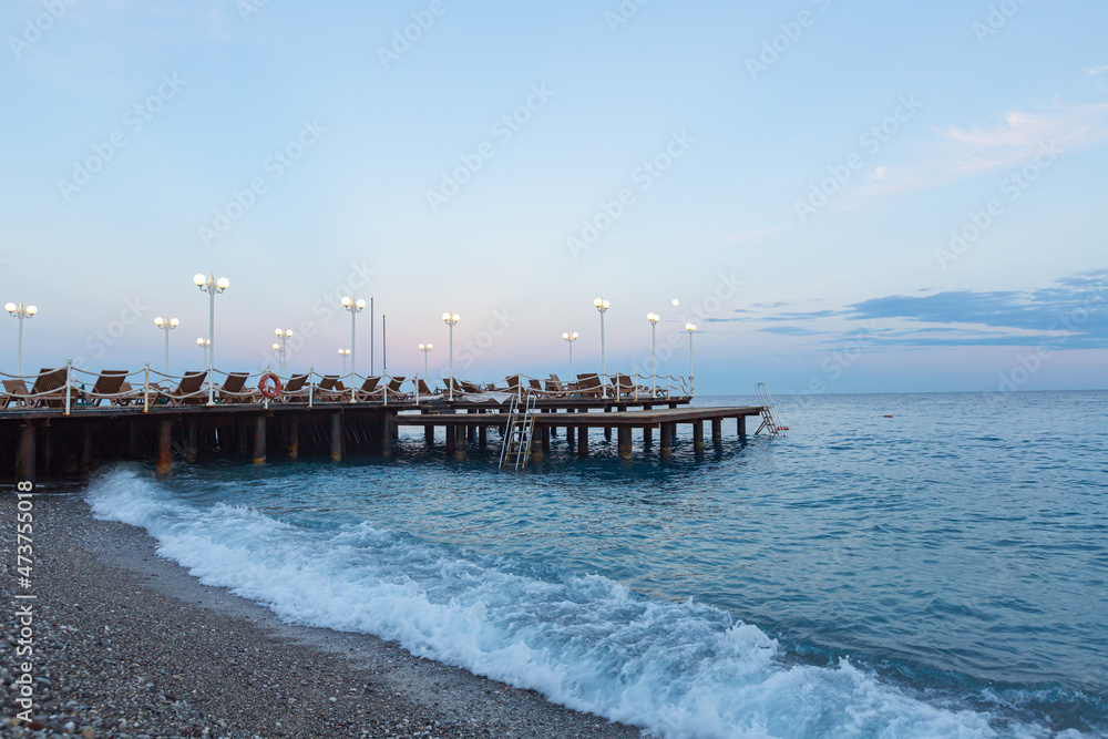 Fototapeta premium wooden sea pier with sun loungers