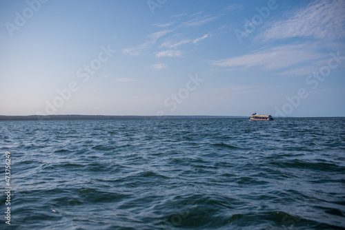 Ferry seen traveling across ocean with clear sky © rushay