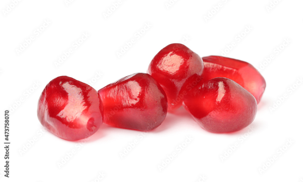 Juicy red pomegranate seeds on white background