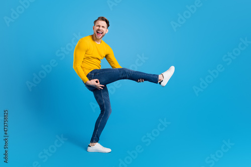 Full length body size photo of funky guy imagine playing guitar isolated bright blue color background