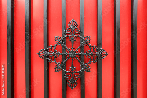 The iron decorative structure is in the red background