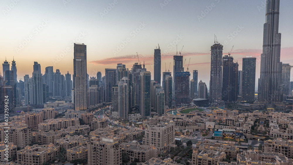 Obraz premium Dubai's business bay towers aerial day to night timelapse. Rooftop view of some skyscrapers