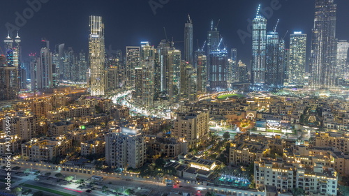 Futuristic aerial night cityscape timelapse with illuminated architecture of Dubai downtown, United Arab Emirates.