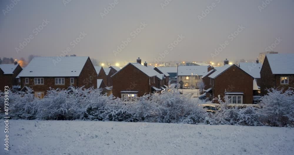 Snow falling on a cold winter day in England in a typical village Snow falling on a cold winter day in England in a typical village