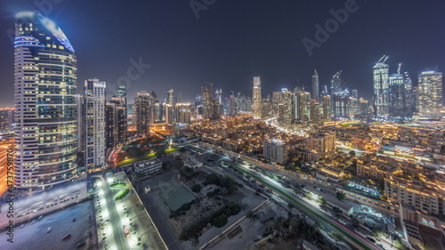 Dubai s business bay towers aerial night timelapse. Rooftop view of some skyscrapers