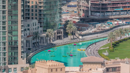 Lake with boats near park in Dubai downtown aerial top view from above timelapse photo