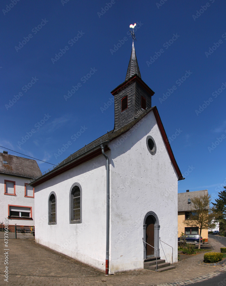 Small baroque chapel with ridge turret and weathercock in the village of Sassen, Eifel region in Germany Small baroque chapel with ridge turret and weathercock in the village of Sassen, Eifel region in Germany