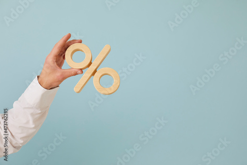 Fotografie Human hand holding percent symbol